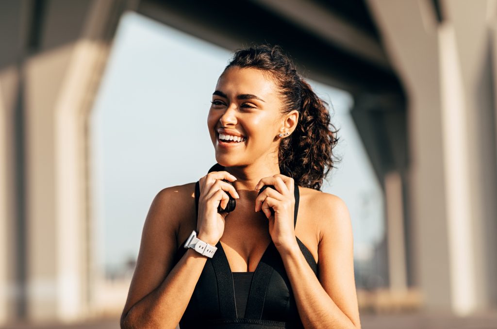 Beautiful happy woman holding headphones